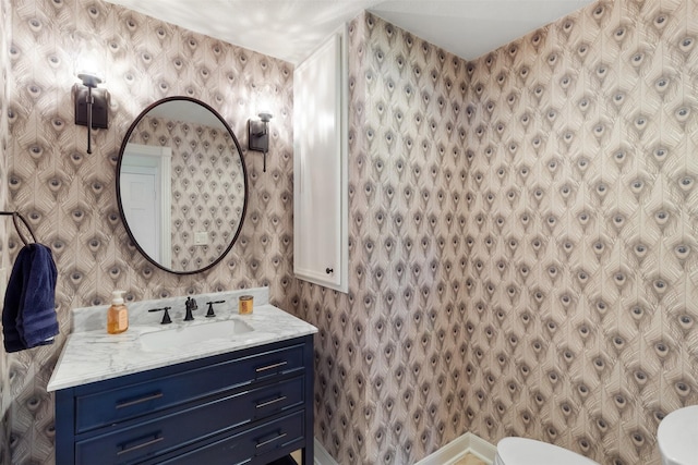 2215 Pecan Lake Dr, Richmond, TX 77406 - bathroom featuring toilet, wallpapered walls, and vanity