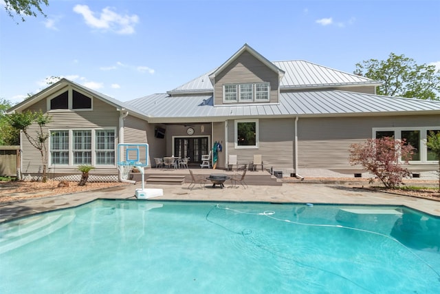 2215 Pecan Lake Dr, Richmond, TX 77406 - back of property with an outdoor pool, a patio area, crawl space, a fire pit, and metal roof