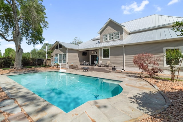 2215 Pecan Lake Dr, Richmond, TX 77406 - rear view of property with a patio area, metal roof, and fence