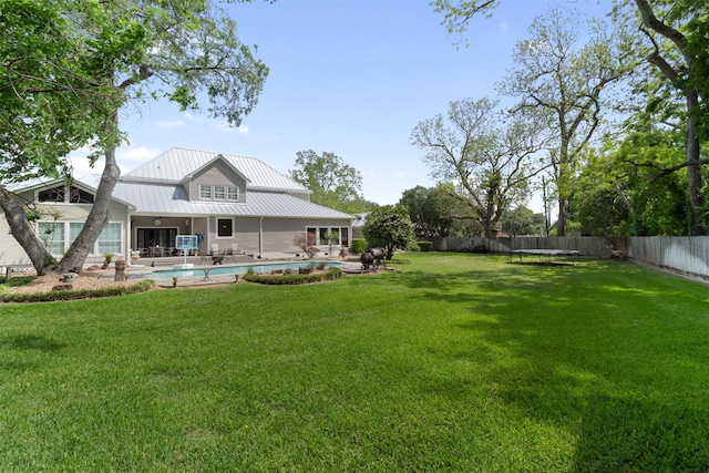 2215 Pecan Lake Dr, Richmond, TX 77406 - rear view of house featuring metal roof and a patio area