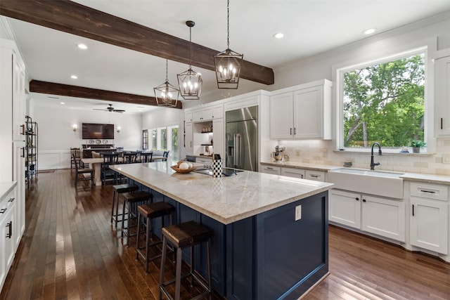 2215 Pecan Lake Dr, Richmond, TX 77406 - kitchen with stainless steel built in refrigerator, a sink, dark wood-type flooring, beam ceiling, and light stone counters