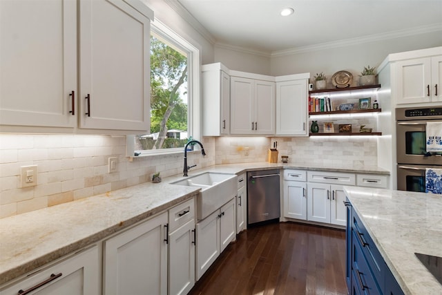2215 Pecan Lake Dr, Richmond, TX 77406 - kitchen featuring stainless steel appliances, a sink, white cabinetry, light stone counters, and crown molding