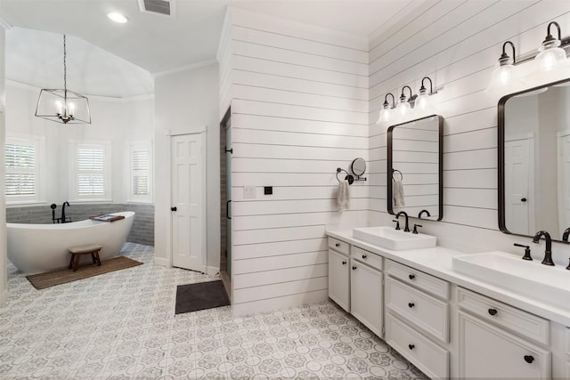 2215 Pecan Lake Dr, Richmond, TX 77406 - bathroom featuring a chandelier, crown molding, a soaking tub, tile patterned flooring, and double vanity