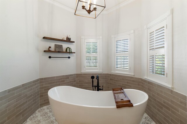 2215 Pecan Lake Dr, Richmond, TX 77406 - full bathroom with tile walls, tile patterned flooring, a wainscoted wall, a chandelier, and a freestanding tub