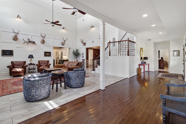 2215 Pecan Lake Dr, Richmond, TX 77406 - living area with ceiling fan, stairs, ornamental molding, a high ceiling, and wood finished floors