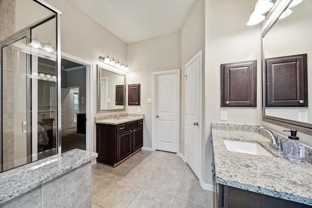 bathroom with two vanities, a sink, a shower stall, and tile patterned floors