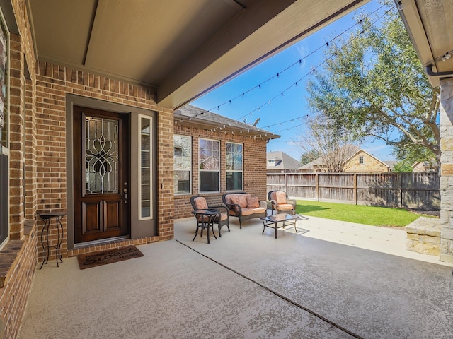 view of patio featuring an outdoor living space and a fenced backyard