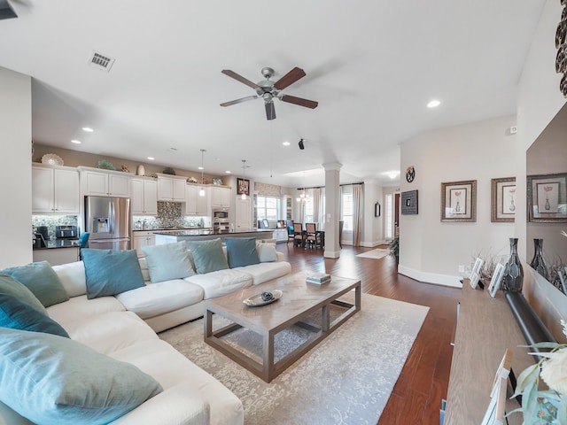 living room featuring recessed lighting, visible vents, ceiling fan, and decorative columns