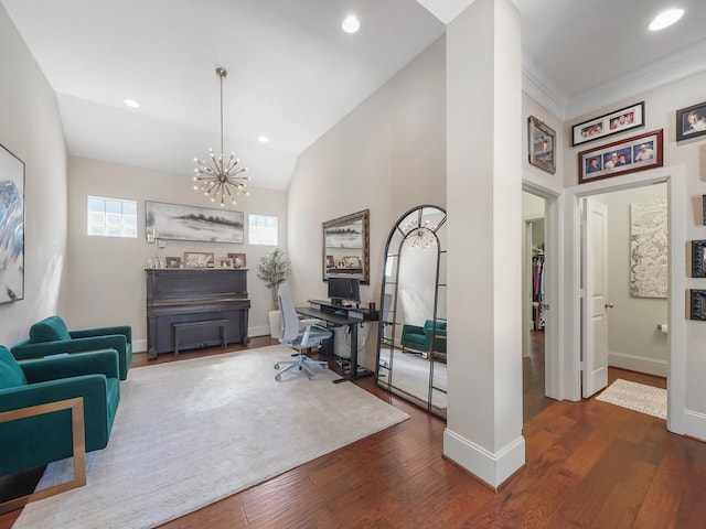 office space with an inviting chandelier, a wealth of natural light, wood finished floors, and baseboards