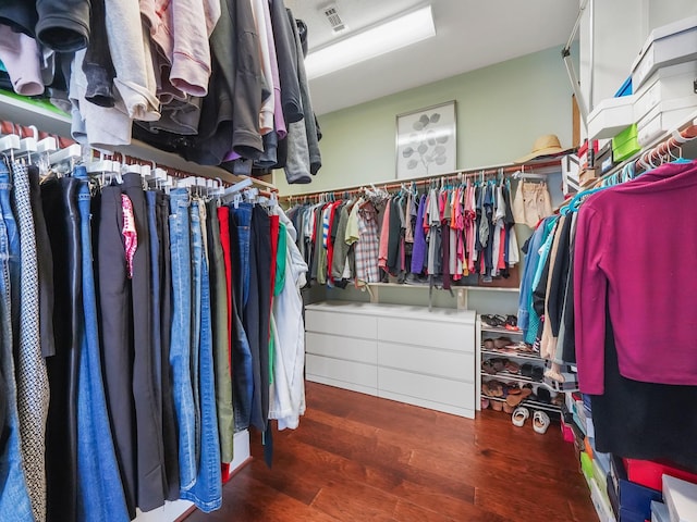 walk in closet with visible vents and wood finished floors
