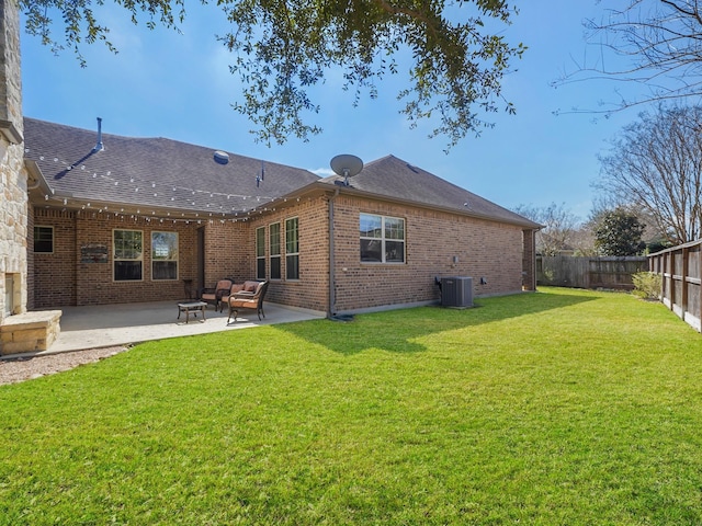 back of house with central AC unit, a patio, brick siding, and a fenced backyard