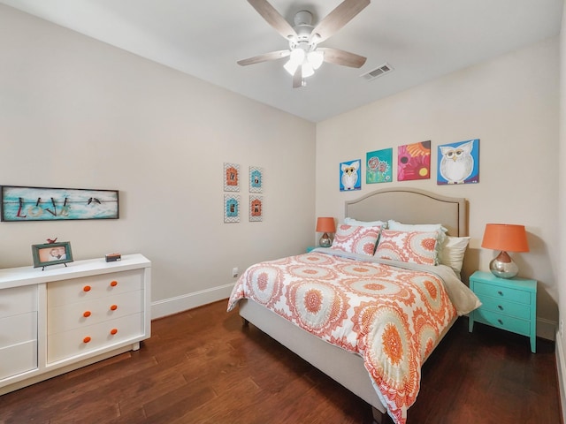 bedroom featuring dark wood finished floors, visible vents, ceiling fan, and baseboards