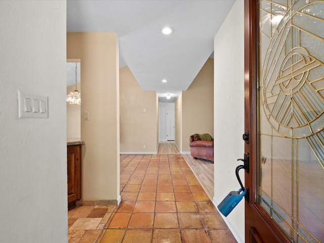 hall with recessed lighting and baseboards