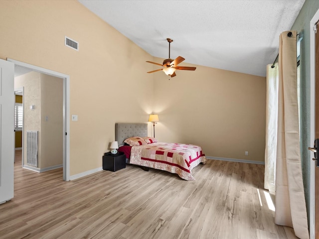 bedroom featuring visible vents, a ceiling fan, baseboards, and wood finished floors