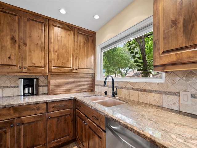 kitchen with decorative backsplash, recessed lighting, light stone counters, a sink, and dishwasher