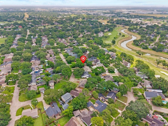 drone / aerial view with view of golf course and a residential view