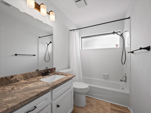 bathroom featuring visible vents, shower / tub combo with curtain, and wood finished floors