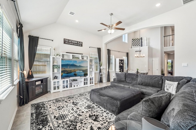 living area with ceiling fan with notable chandelier, arched walkways, recessed lighting, and lofted ceiling