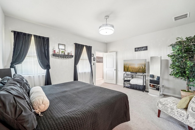 carpeted bedroom featuring baseboards and visible vents