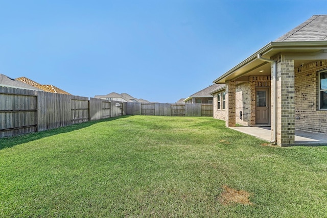 view of yard featuring a patio area and a fenced backyard
