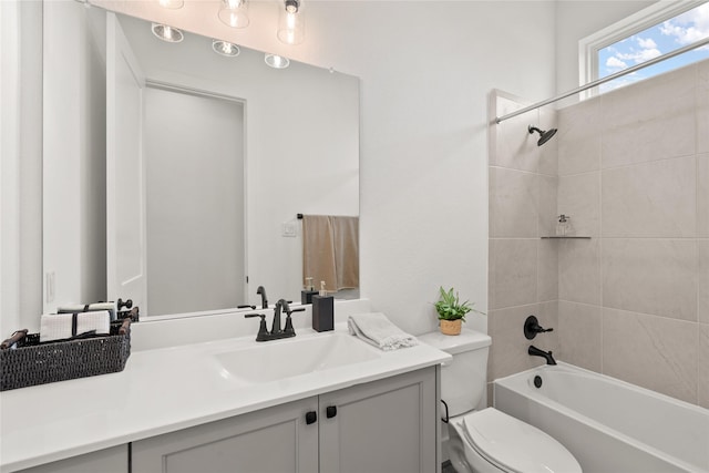 bathroom featuring toilet, shower / bathtub combination, and vanity