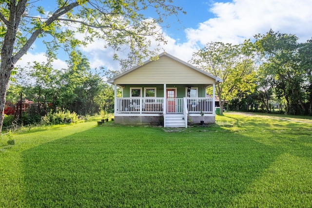 view of front of house with covered porch and a front lawn