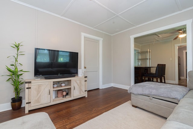 living area featuring dark wood-type flooring, attic access, ornamental molding, and baseboards