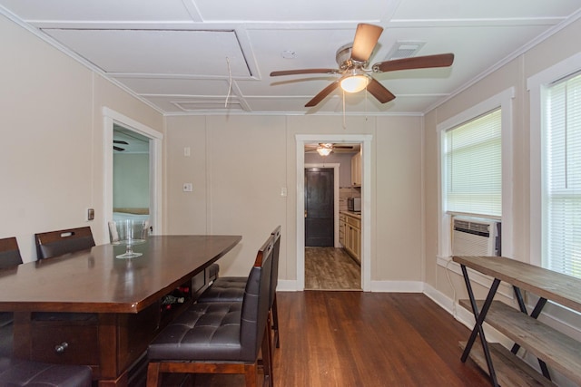 dining space featuring dark wood finished floors, cooling unit, attic access, baseboards, and a ceiling fan