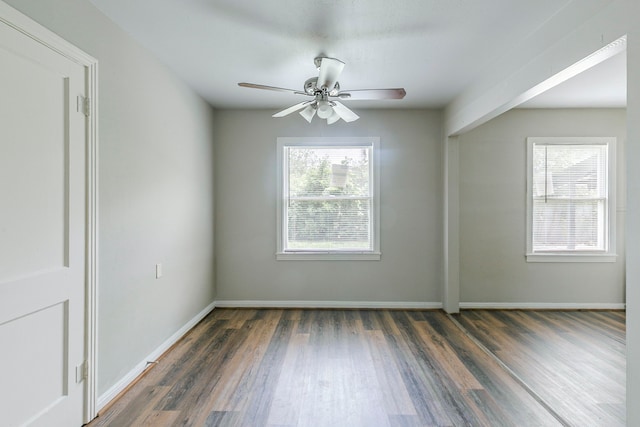 unfurnished room featuring a ceiling fan, wood finished floors, and baseboards