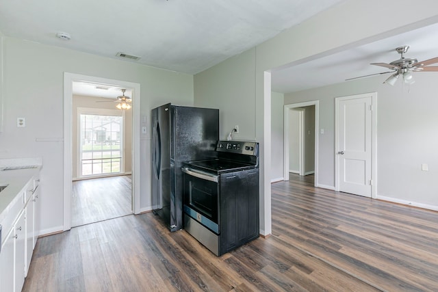 kitchen featuring stainless steel electric range oven, a ceiling fan, visible vents, freestanding refrigerator, and dark wood finished floors