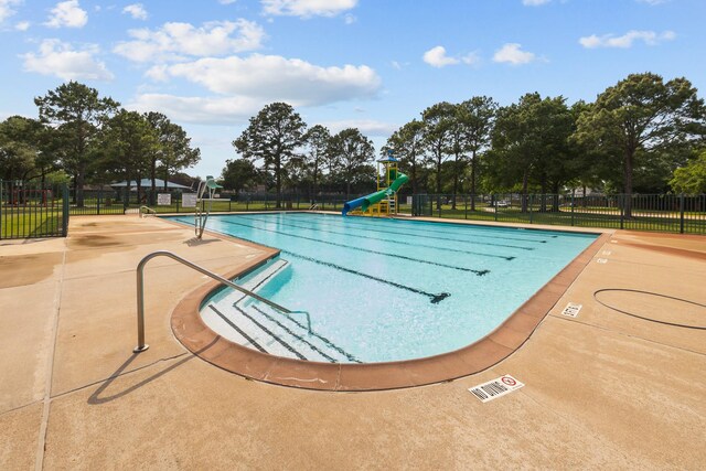 16511 Crystal View Ct, Houston, TX 77095 - community pool featuring a patio, a water slide, and fence