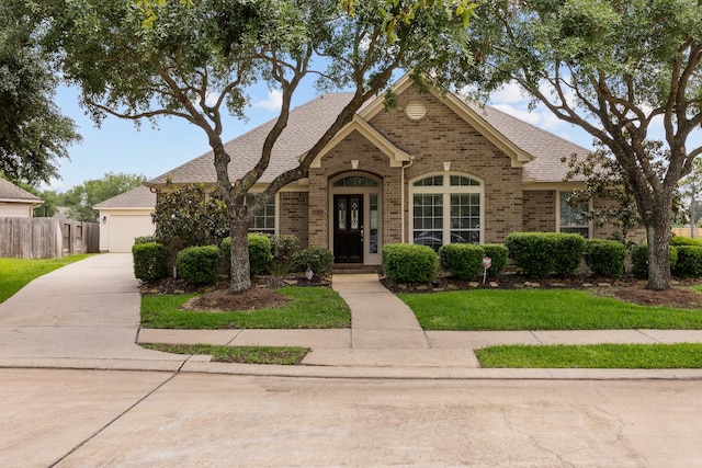 16511 Crystal View Ct, Houston, TX 77095 - ranch-style home featuring driveway, roof with shingles, a garage, brick siding, and fence