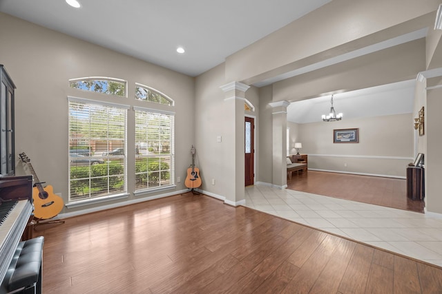 16511 Crystal View Ct, Houston, TX 77095 - interior space featuring decorative columns, wood finished floors, baseboards, recessed lighting, and a notable chandelier
