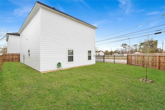 exterior space with a yard and a fenced backyard