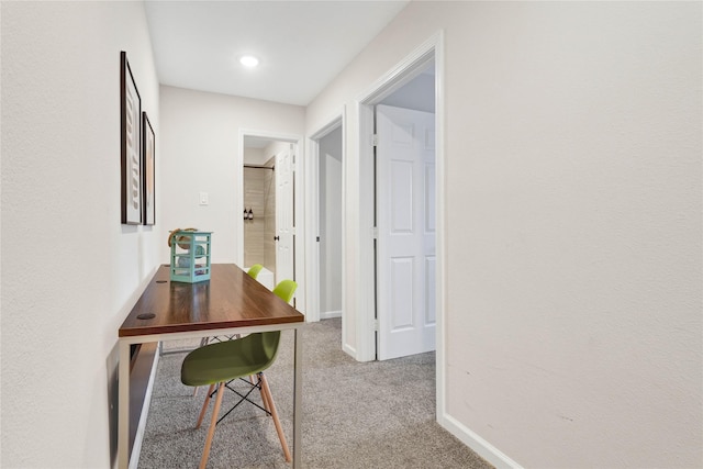 hallway with baseboards and carpet flooring