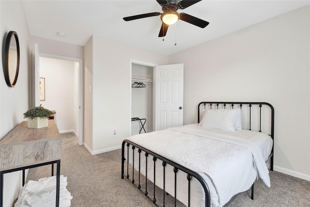 bedroom featuring a ceiling fan, a closet, light carpet, and baseboards