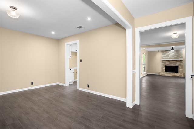 106 Rosewood Dr, Crockett, TX 75835 - interior space with a fireplace, dark wood-style flooring, visible vents, and baseboards
