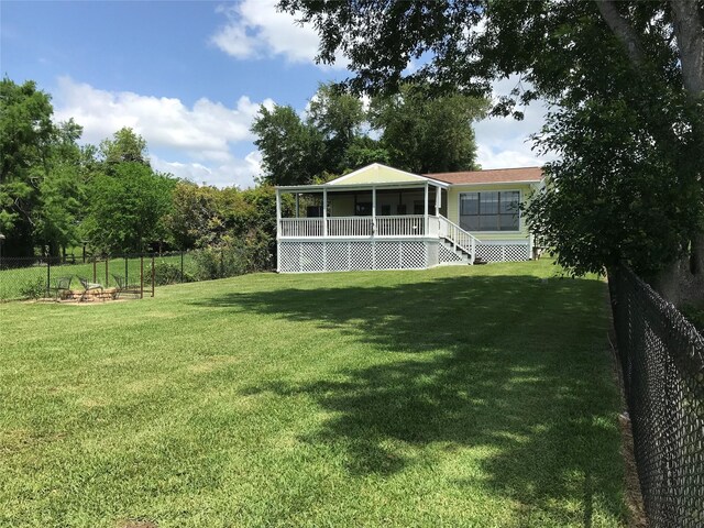 104 Bayside St, Livingston, TX 77351 - view of yard with a sunroom and a fenced backyard
