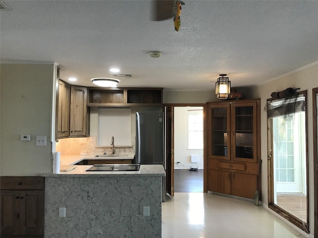 104 Bayside St, Livingston, TX 77351 - kitchen featuring a sink, open shelves, black electric stovetop, crown molding, and a peninsula