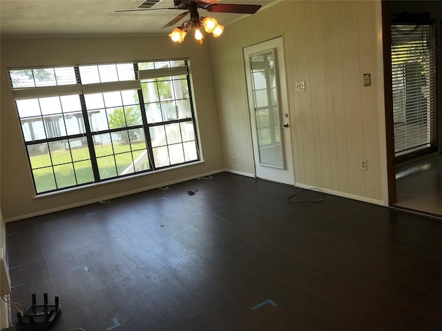 104 Bayside St, Livingston, TX 77351 - unfurnished room featuring dark wood-type flooring, ceiling fan, plenty of natural light, and baseboards