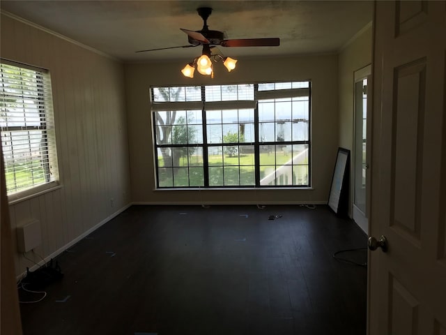 104 Bayside St, Livingston, TX 77351 - empty room with a ceiling fan, crown molding, dark wood finished floors, and baseboards
