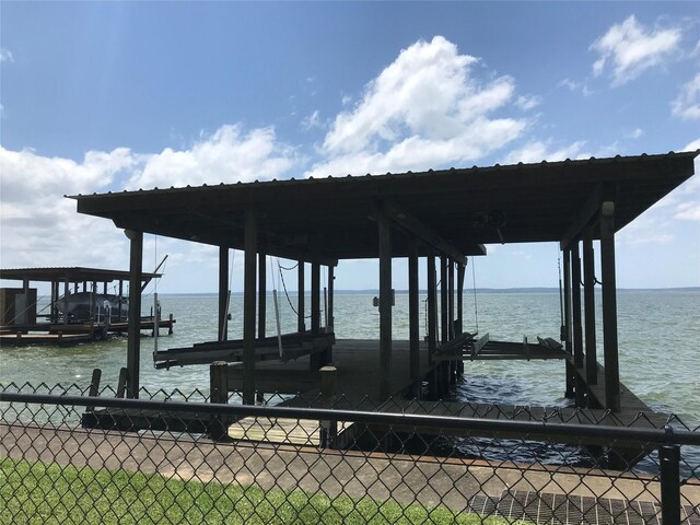 104 Bayside St, Livingston, TX 77351 - dock area with fence, a water view, and boat lift