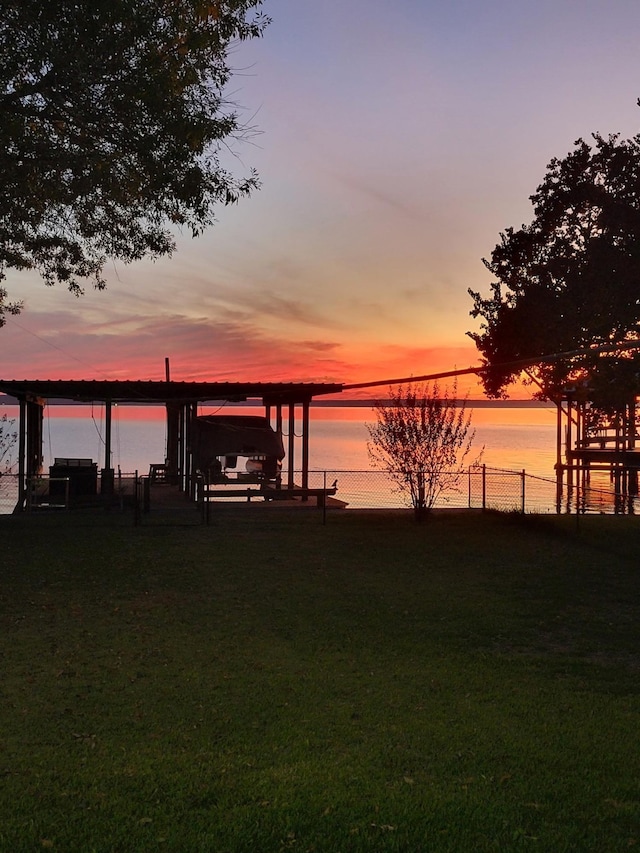 104 Bayside St, Livingston, TX 77351 - dock area with fence, a yard, a water view, and boat lift
