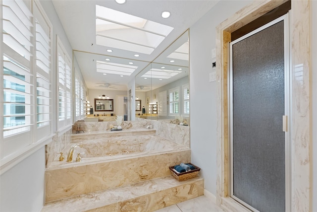 full bathroom featuring recessed lighting, a skylight, a shower stall, and a bath