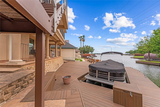 wooden terrace featuring a water view and a boat dock