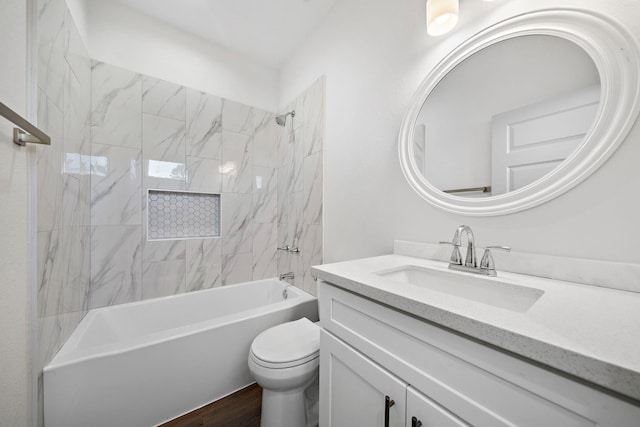 bathroom with wood finished floors, toilet,  shower combination, and vanity
