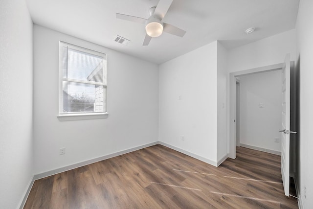 unfurnished bedroom with baseboards, visible vents, and wood finished floors