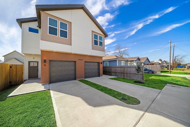 contemporary house featuring brick siding, fence, a garage, driveway, and a front yard