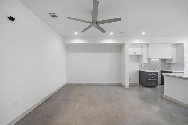 interior space featuring recessed lighting, ceiling fan, finished concrete flooring, white cabinetry, and visible vents