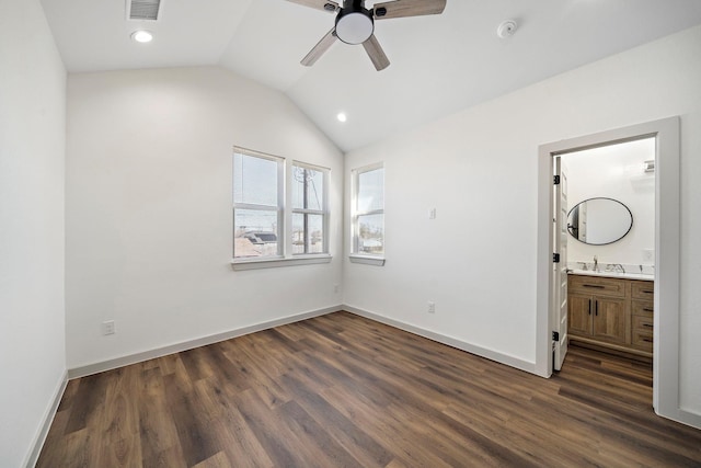 unfurnished bedroom featuring a sink, visible vents, baseboards, vaulted ceiling, and dark wood-type flooring